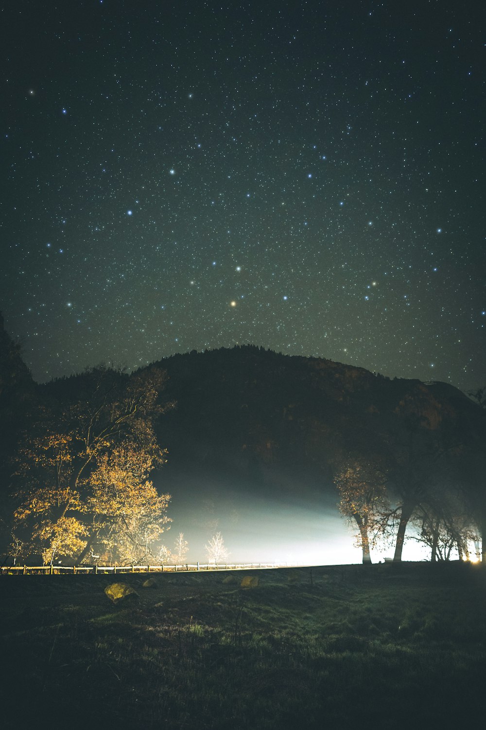 silhouette of mountain under starry night