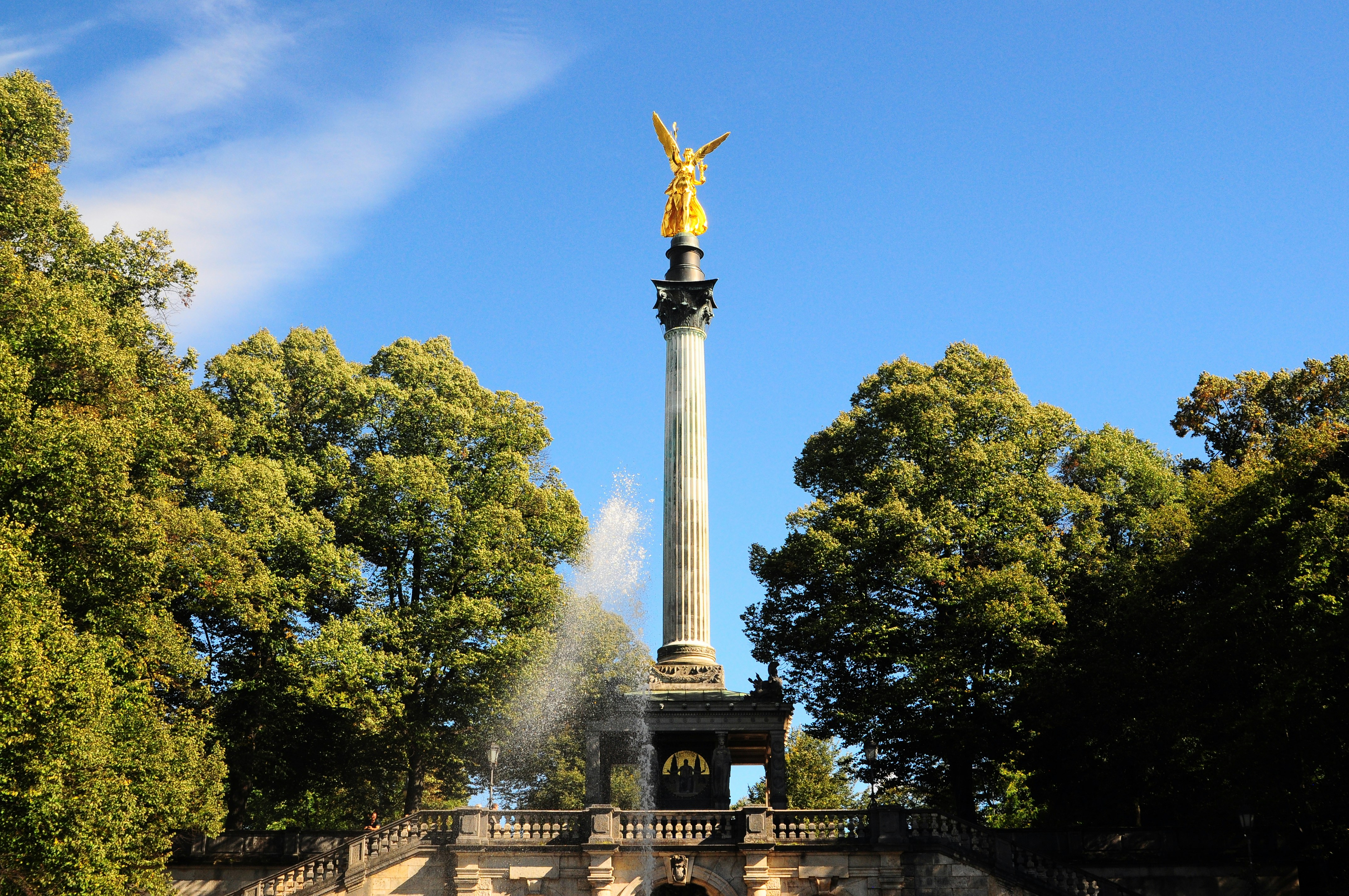 concrete tower in between trees during daytime