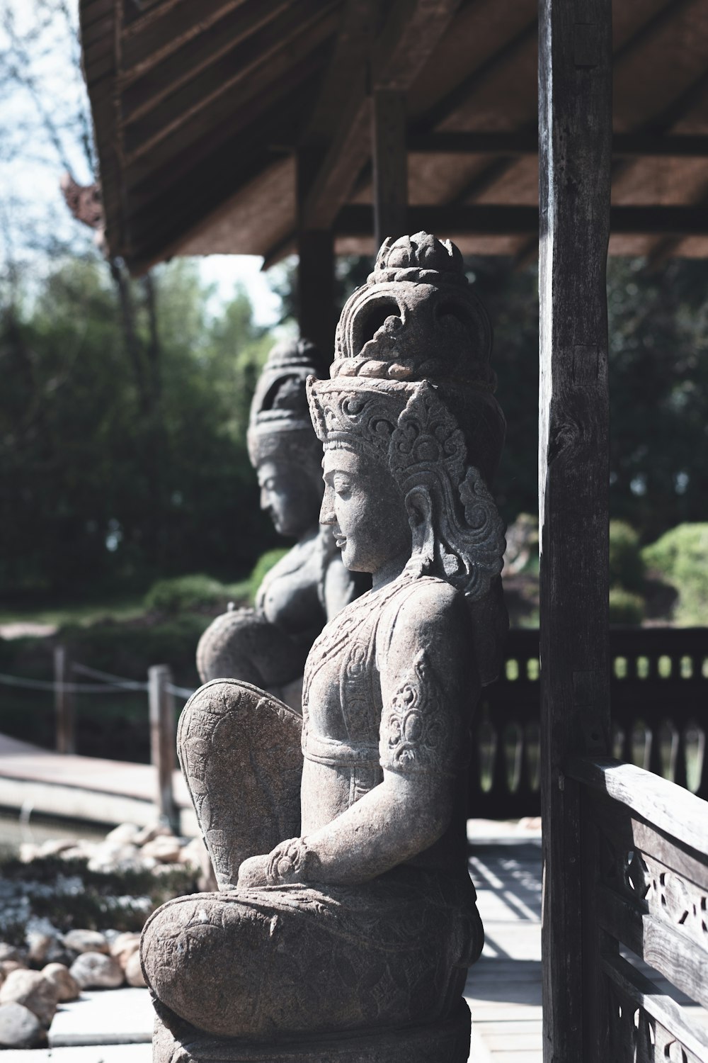 gold statue of a woman sitting on a bench