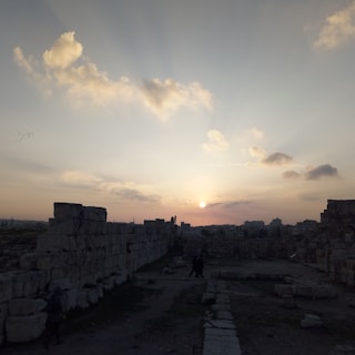 Sunset over the ancient stones of Jerusalem's Old City, with soft golden light illuminating the walls.
