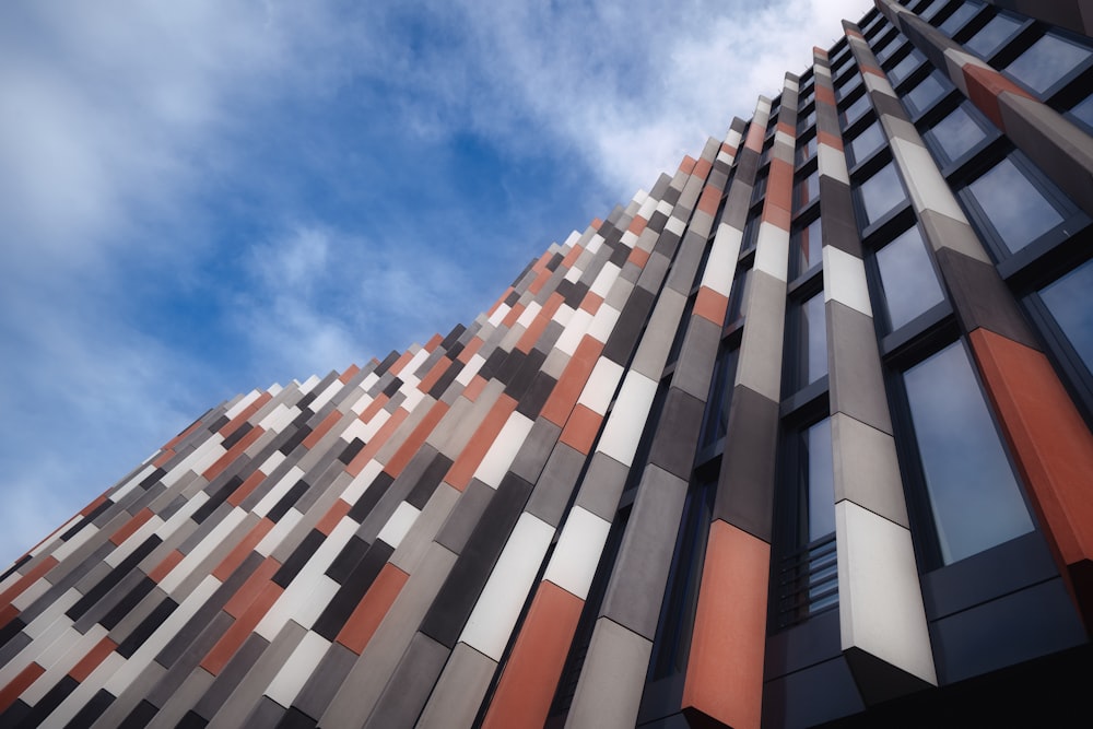 low angle photography of brown, white, and gray building at day time