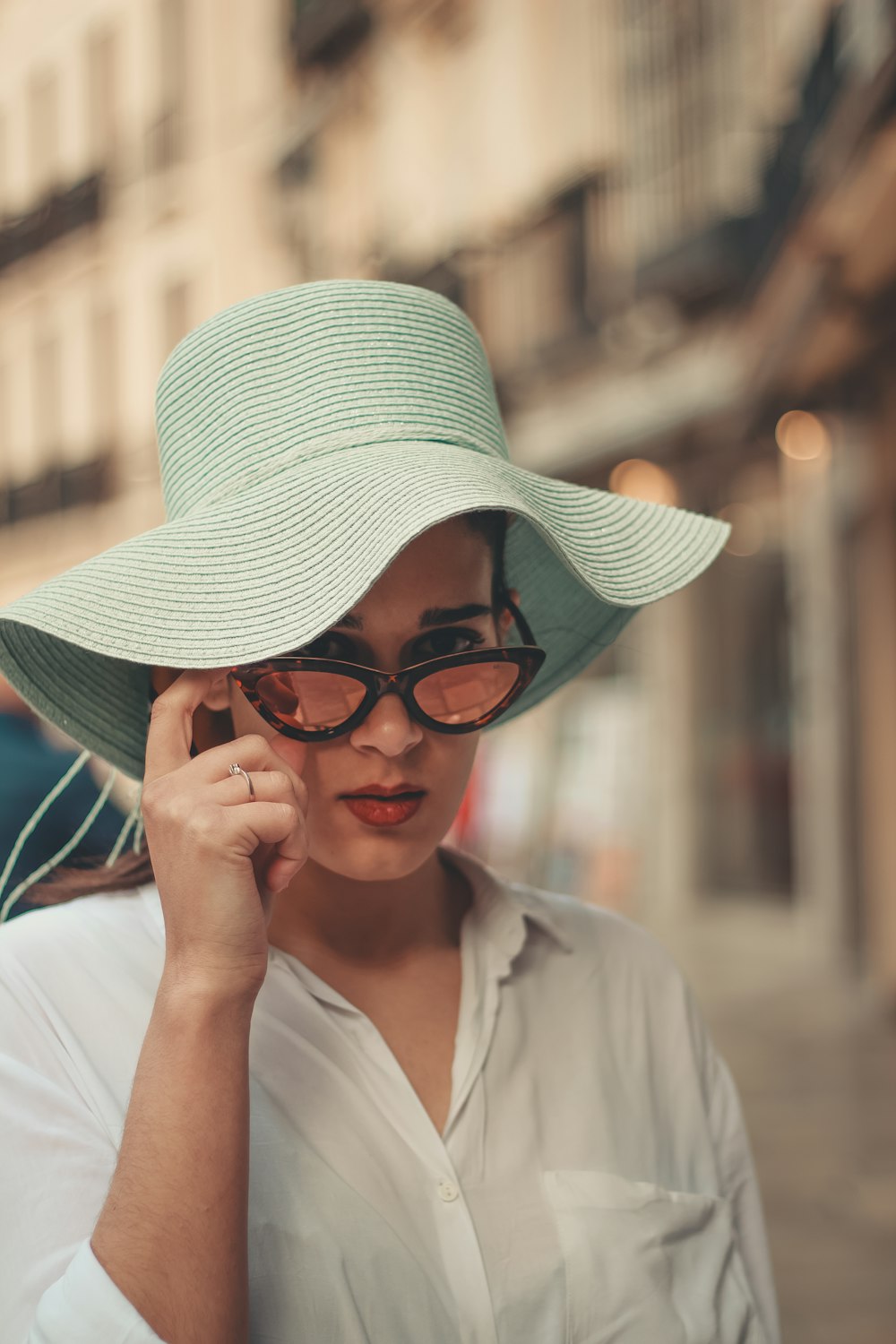 woman wearing teal sun hat