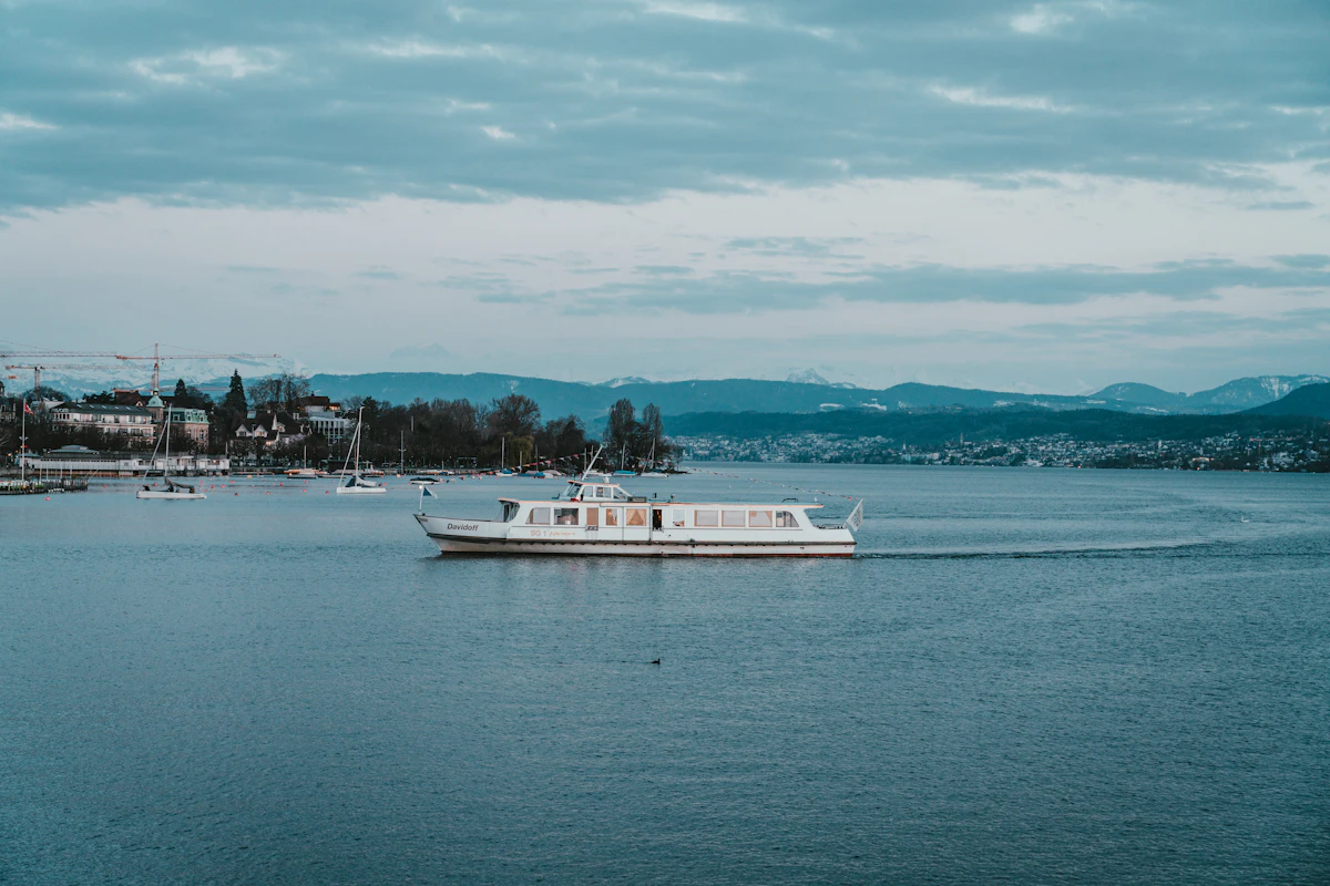 A white boat on calm water on Lake Zurich