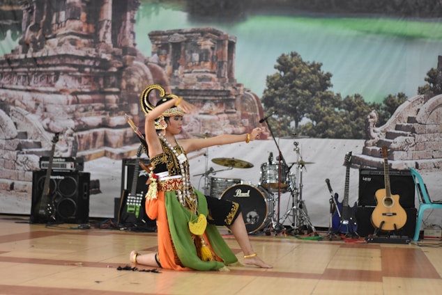 A vibrant photo of a traditional Sri Lankan dancer performing amidst ancient temple ruins.