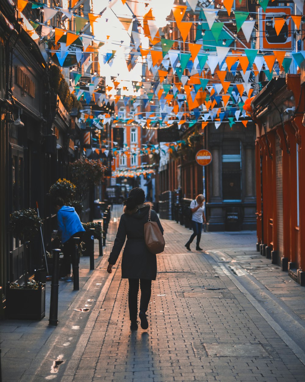 woman between buildings during daytime