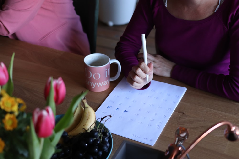 person writing on paper