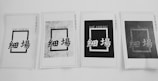 Four printed papers are arranged in a row, each displaying a rectangular design with the text 'SAI' 'COENG' at the top and Chinese characters below. The appearance of each sheet varies, with different levels of contrast and background patterns.