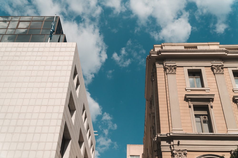 white cloudy blue sky over two high rise buildings