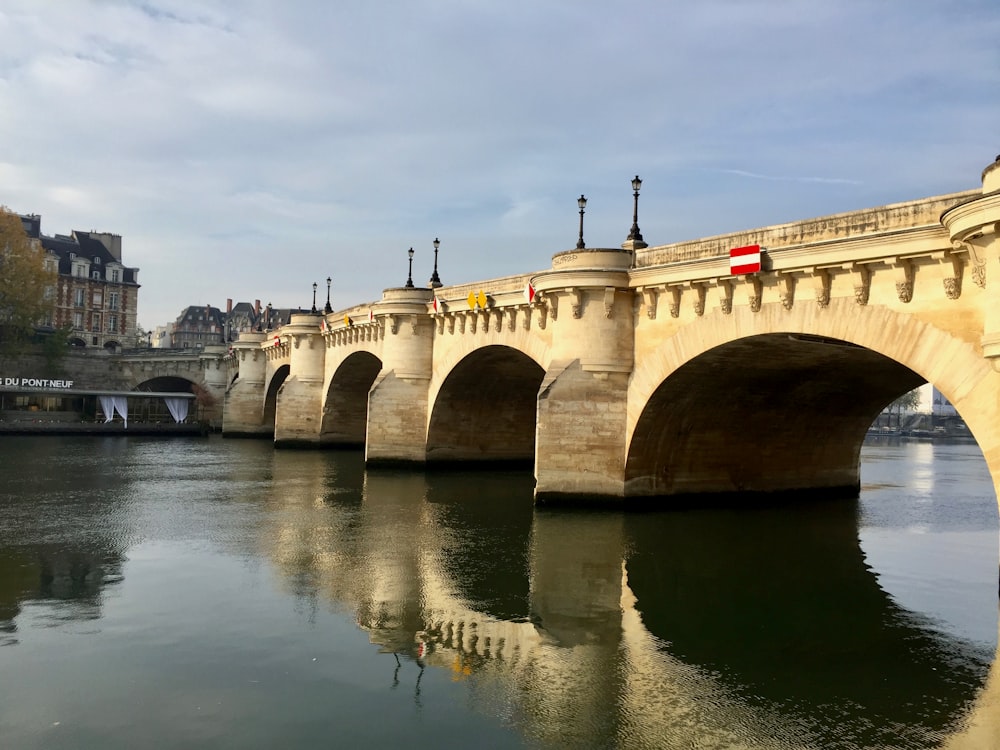 beige concrete bridge near building