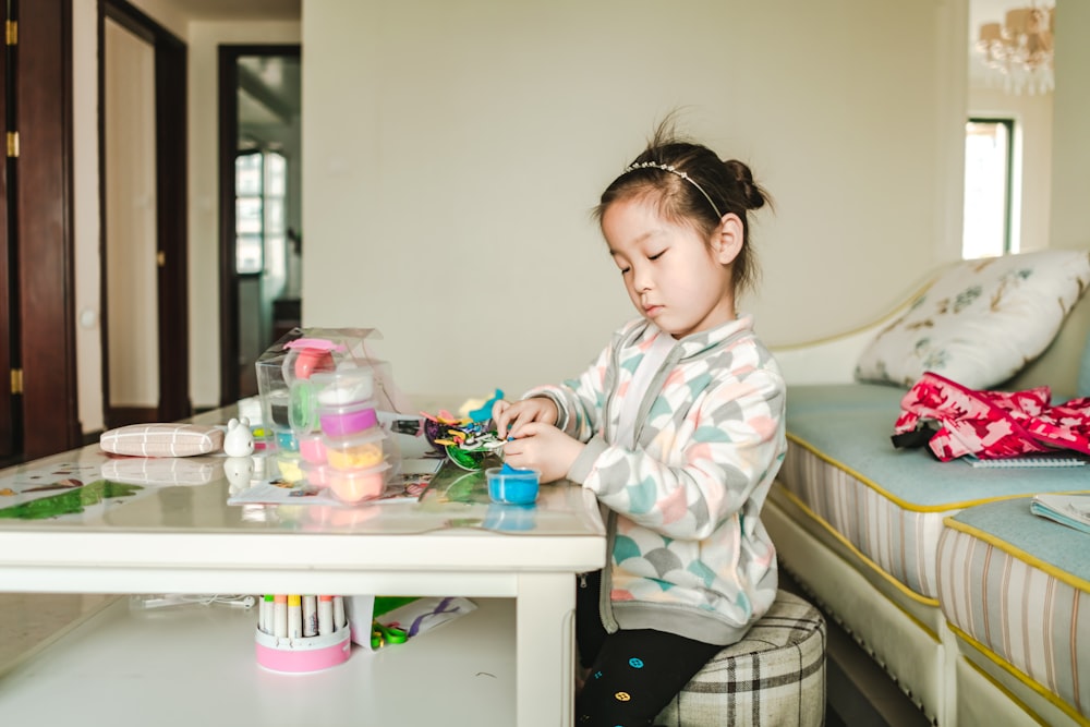 girl sitting by coffee table