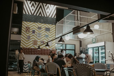 A diverse group of adults practicing English conversation in a cozy cafe setting.