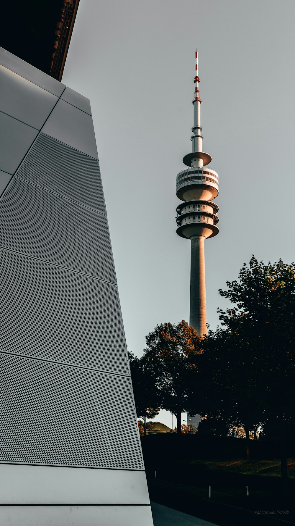 a tall tower with a sky scraper in the background