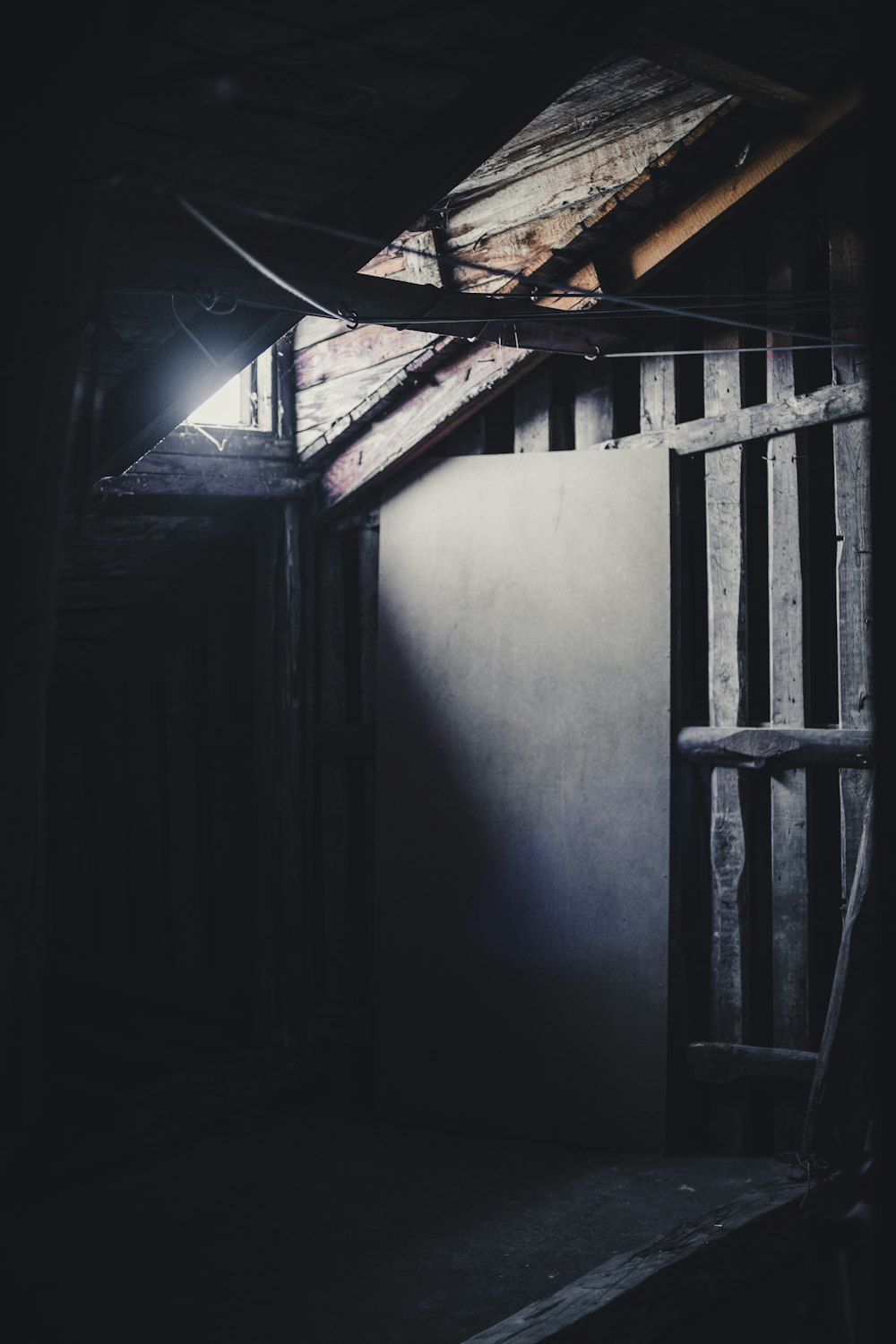 blue wooden door beside white wall