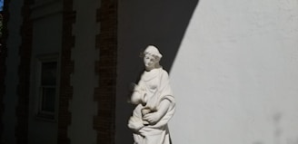 A beautifully finished statue standing against a simple background, capturing its symbolic and artistic essence.