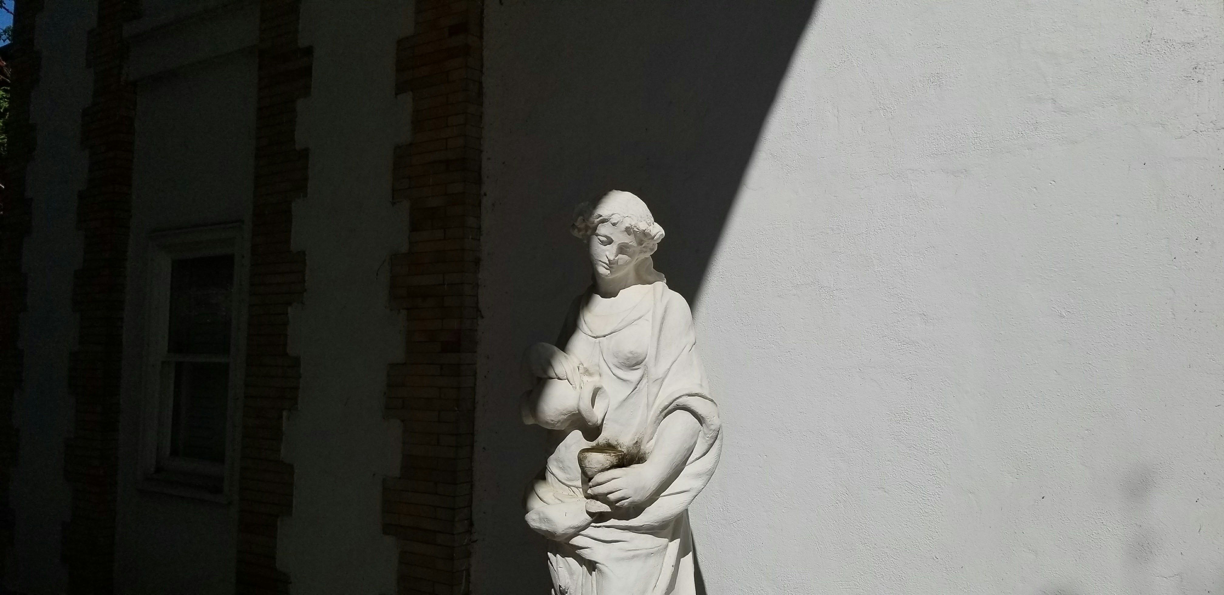 woman holding jar statue