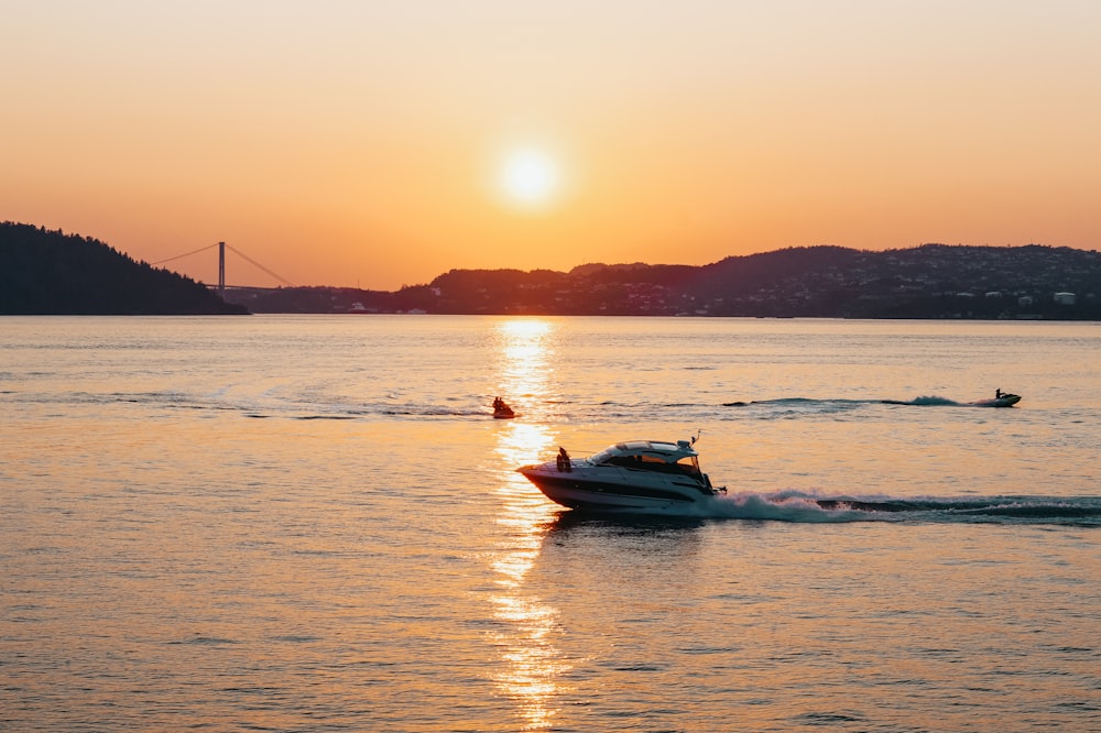 silhouette of boat on sea during sunset