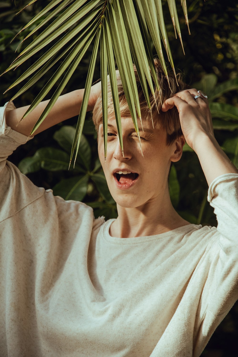 woman in gray shirt near plants