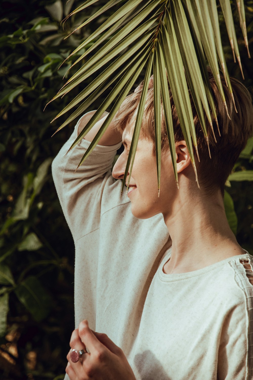 woman in gray shirt near plants