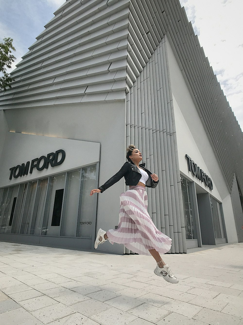 woman jumping near high-rise building