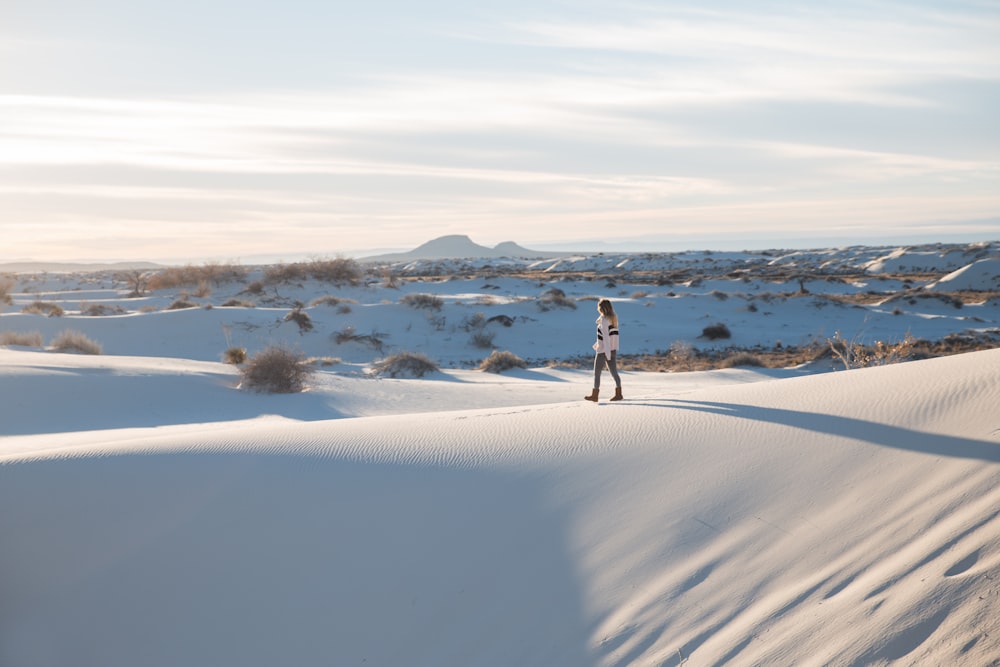 a person standing on top of a snow covered hill