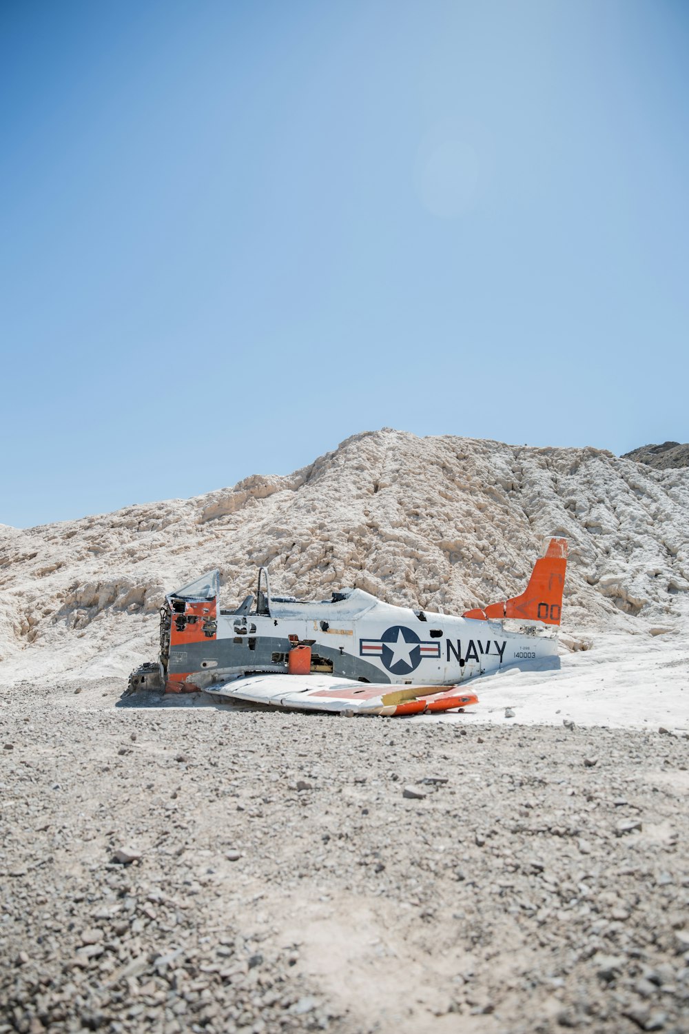 a small airplane sitting on top of a sandy beach