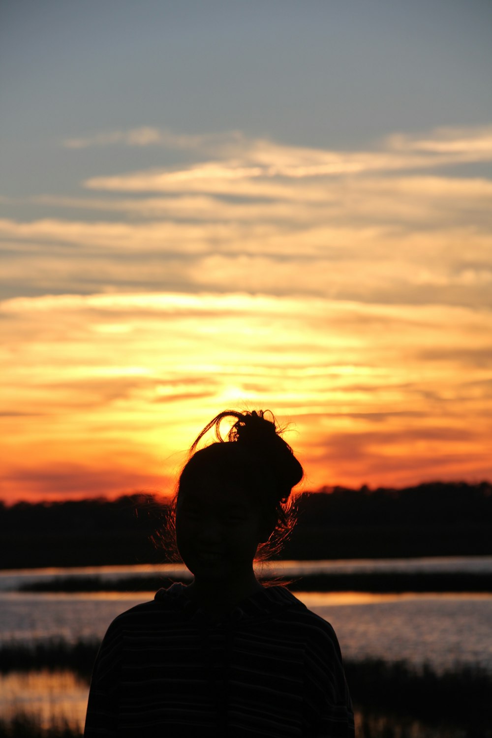 a person standing in front of a sunset