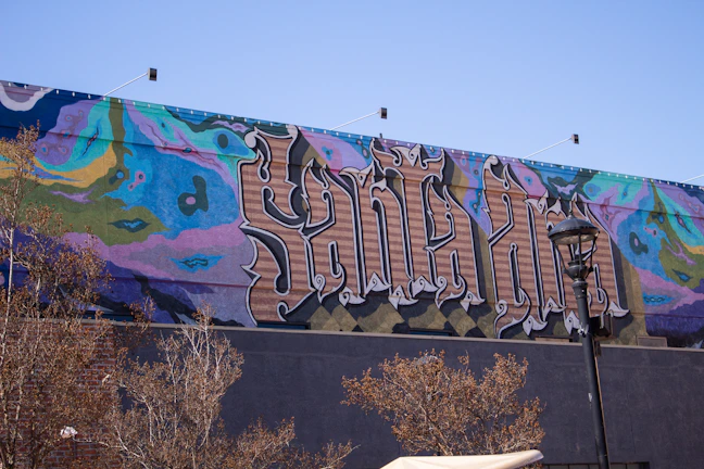 A vibrant mural featuring words and phrases that celebrate creativity and connection.