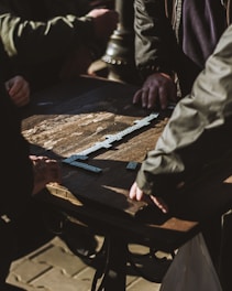 A lively group of friends enjoying a domino tournament in a warmly lit room.