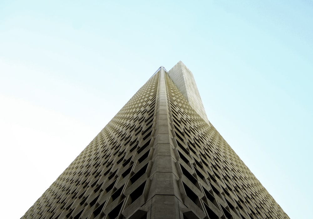 low-angle photography of beige high-rise building