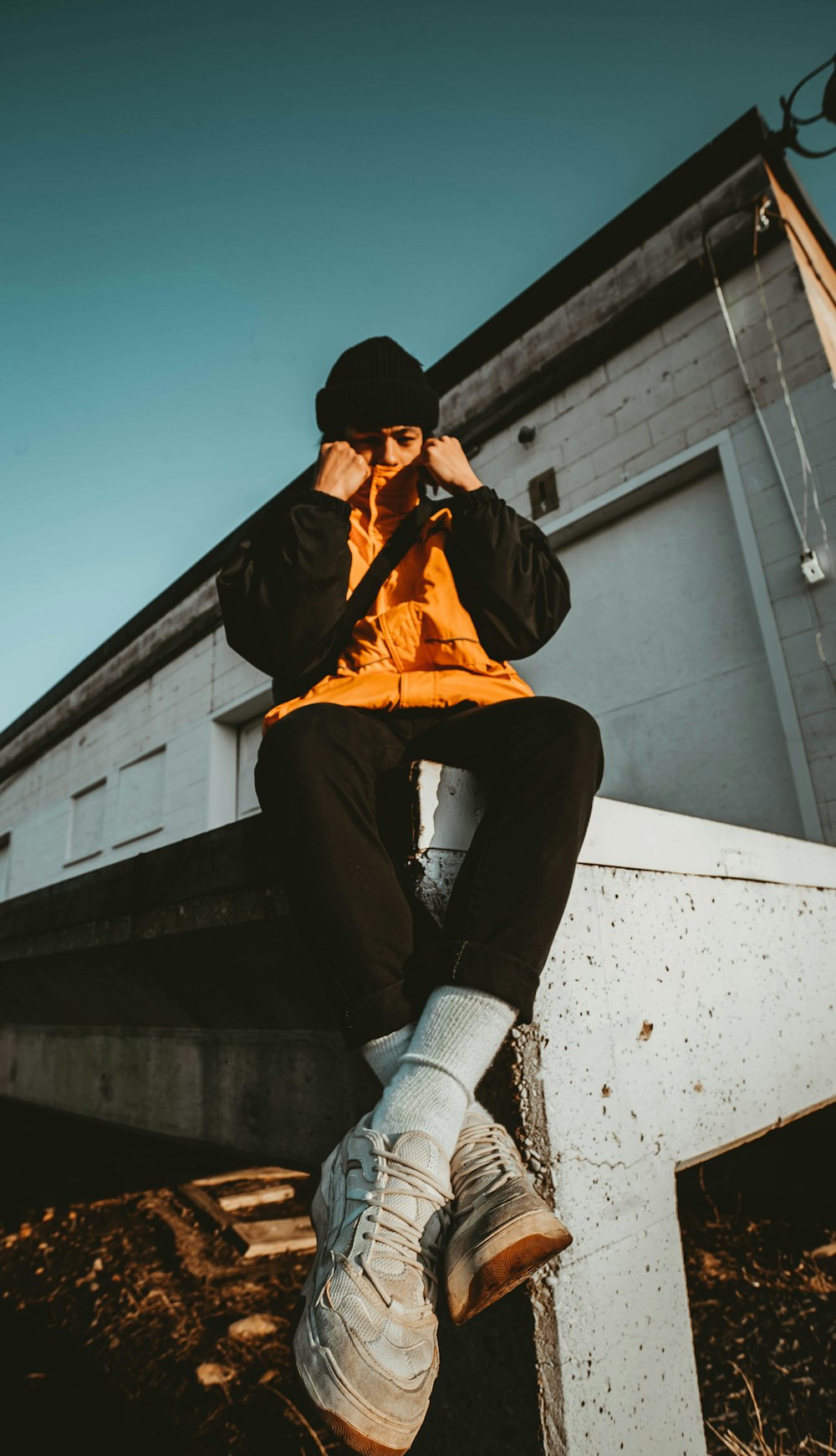 man wearing orange and black jacket