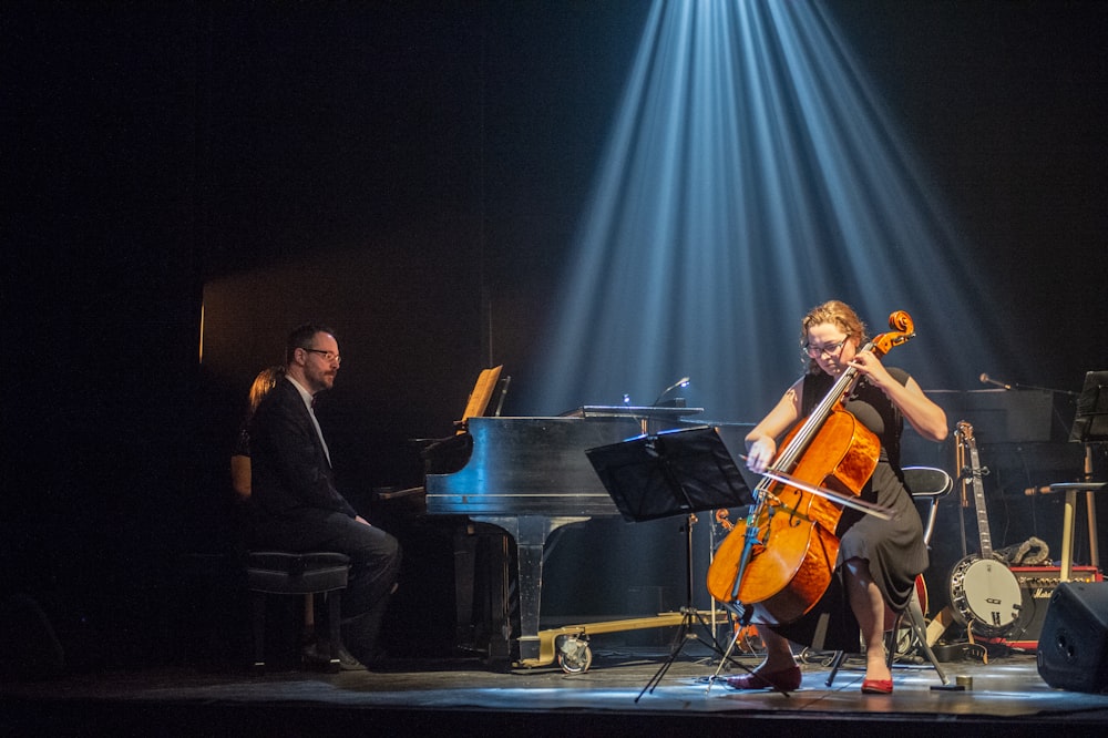 a woman playing a cello on a stage