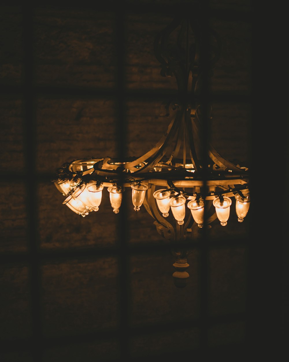 a chandelier hanging from the ceiling in a dark room