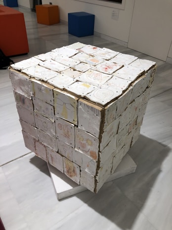 Wide shot of a white cube gallery wall with a single large abstract piece.