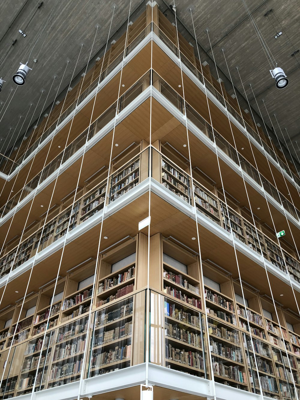 low-angle photography of multi-story bookshelves