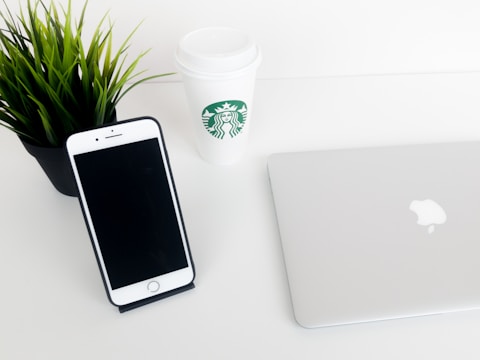 Minimalist workspace with marketing materials and a coffee cup.