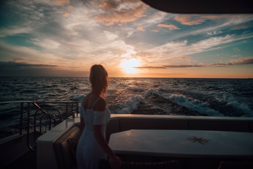 woman standing on white boat