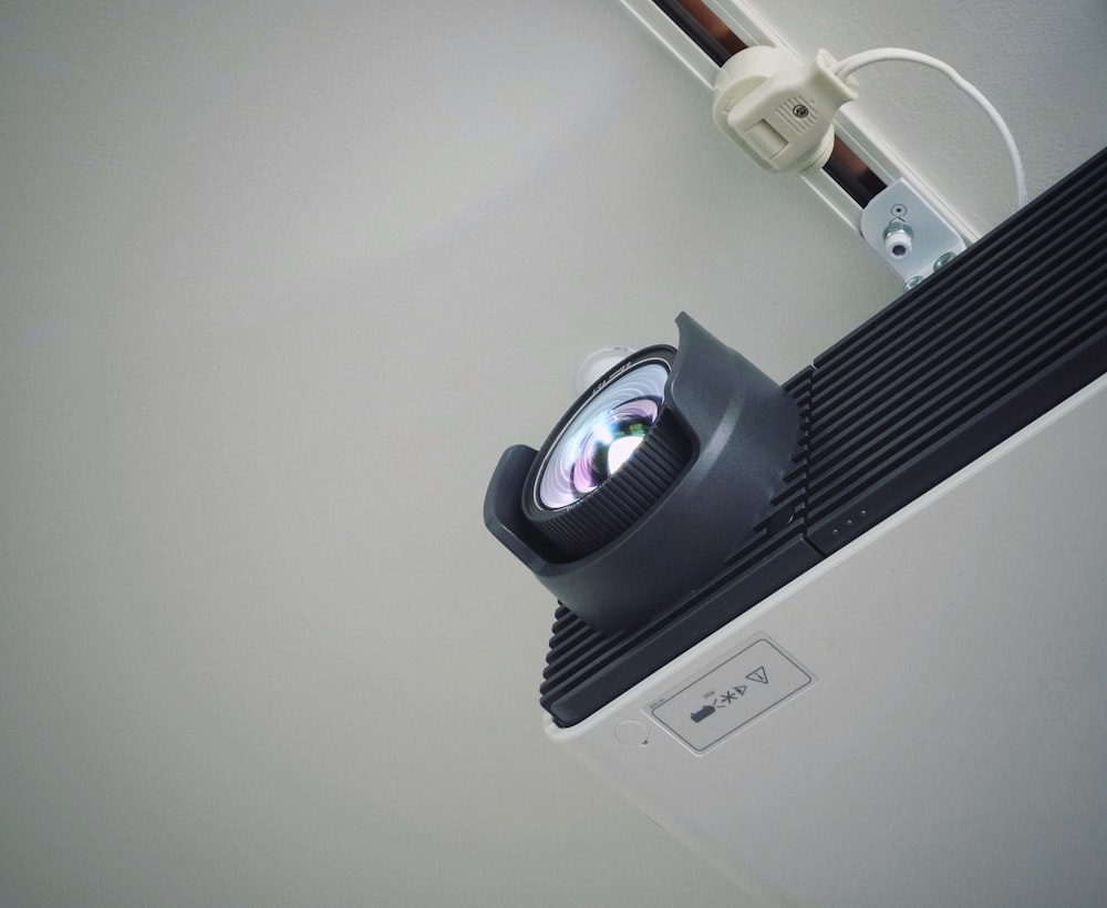 a projector sitting on top of a white wall