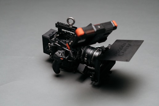 Close-up of a matte box attached to a professional camera lens, highlighting its sleek design and sturdy build.