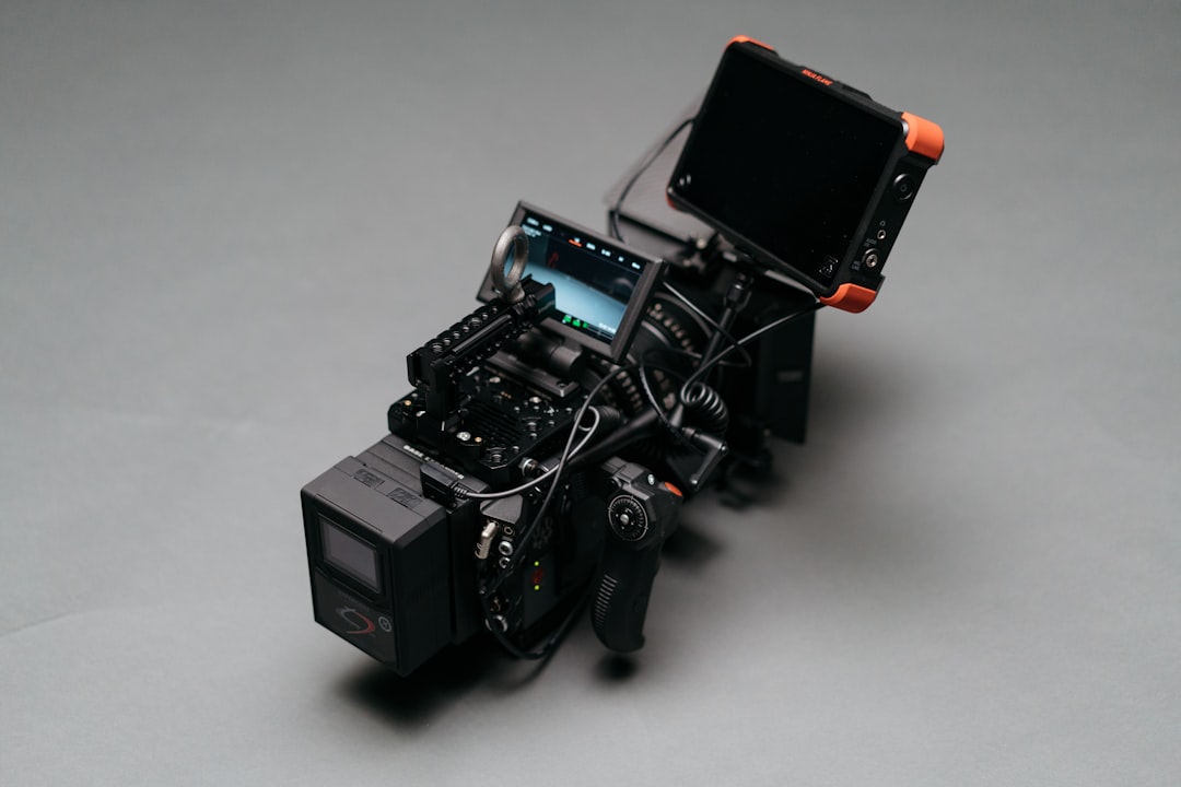 black video camera on gray surface,