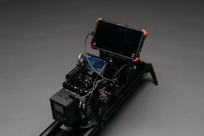 black smartphone attached to camera