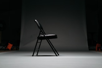 black metal framed padded folding chair