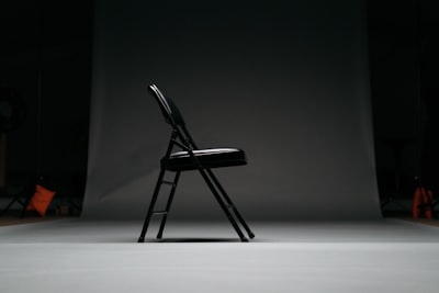 black metal framed padded folding chair chair teams background