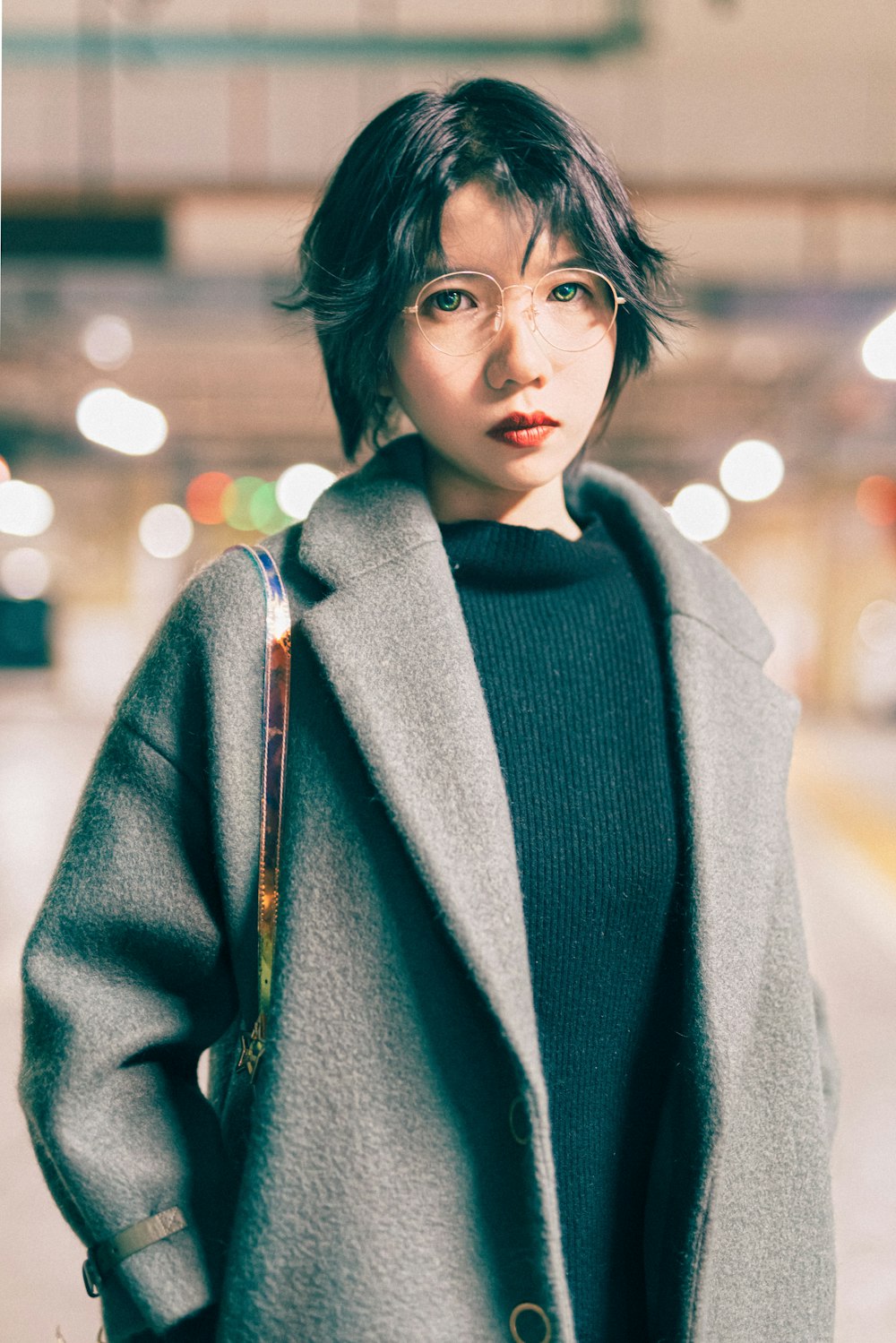 woman in black dress and grey coat