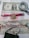 Various types of currency are displayed, including a US one-dollar bill, a Zimbabwean trillion-dollar note, and a historical German note for ten million marks. A magnifying glass, a red pen, and a novelty Bitcoin coin are also present.