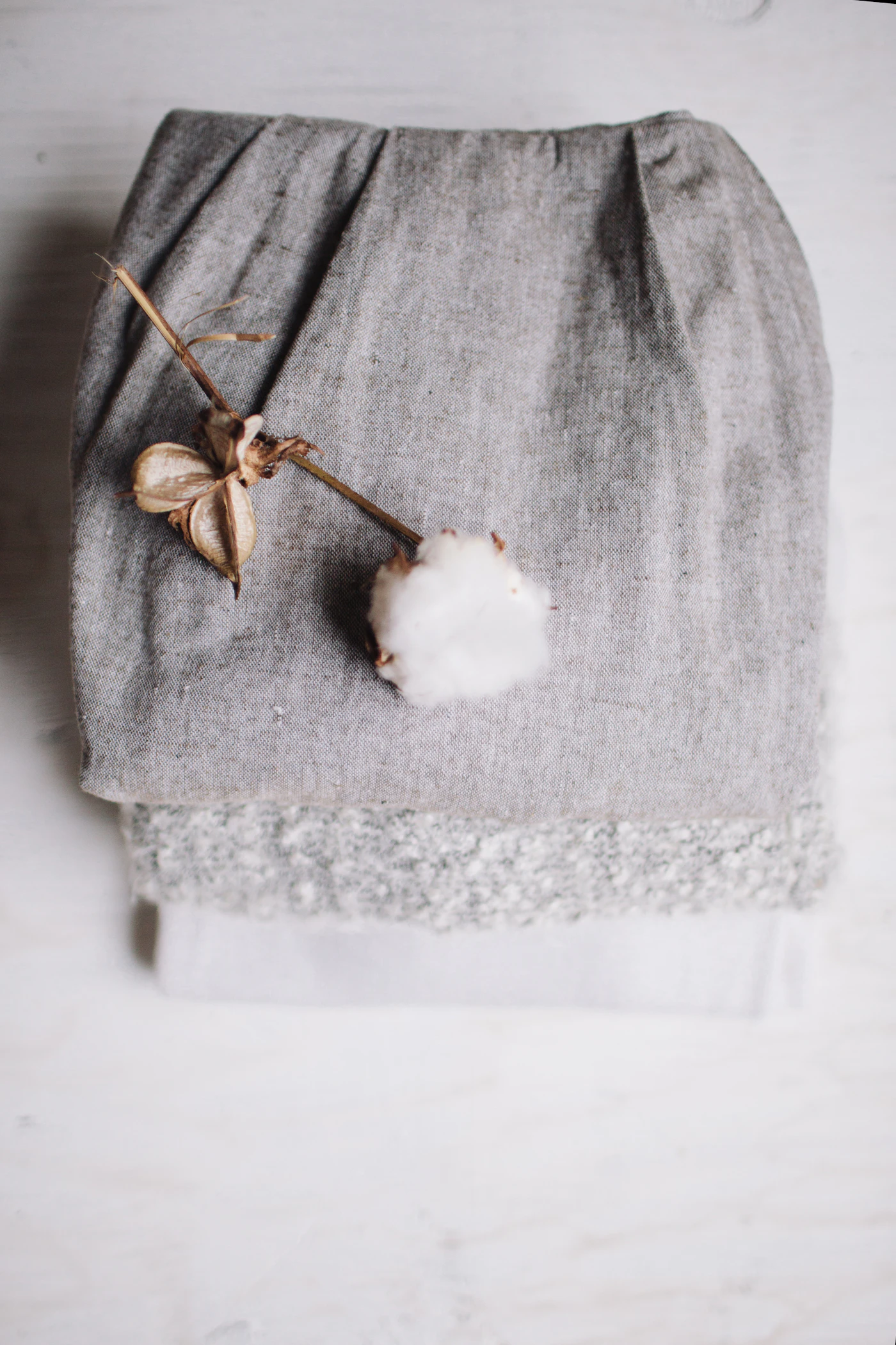 Cotton flower resting on soft textile for a traditional second anniversary gift