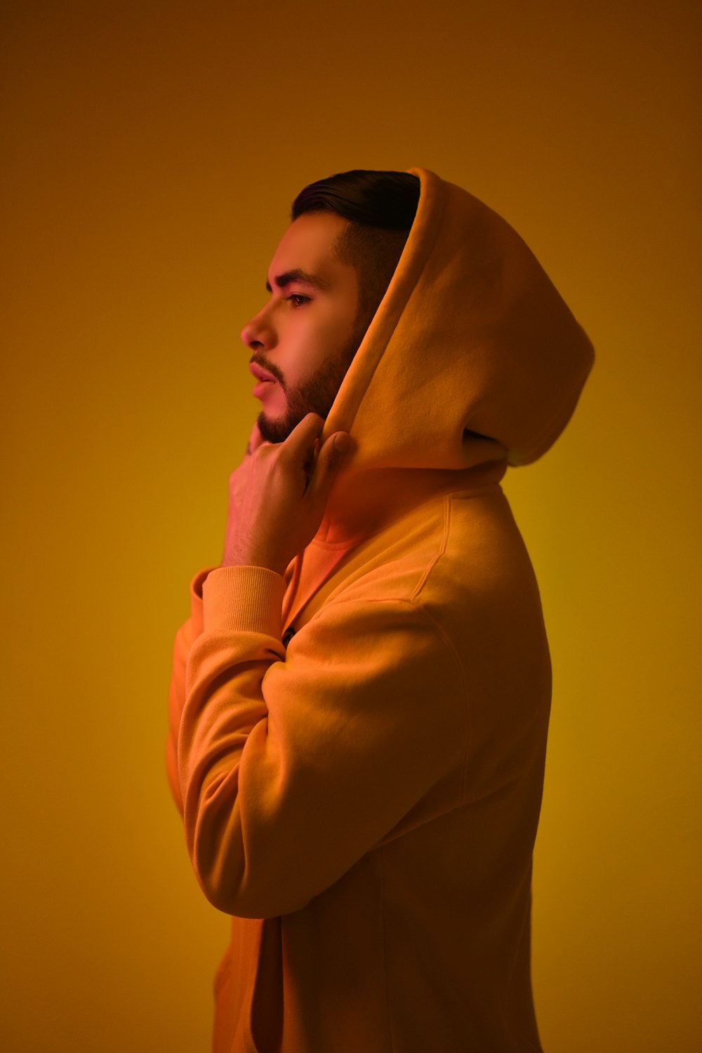 man wearing yellow pullover hoodie