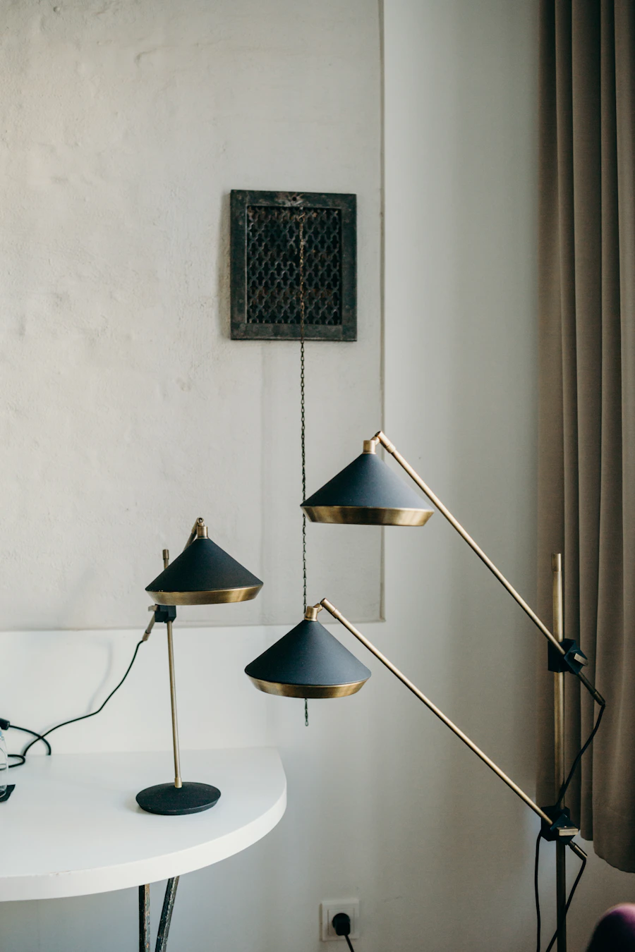 Black and brass reading lamps showing mixed metal lighting finishes