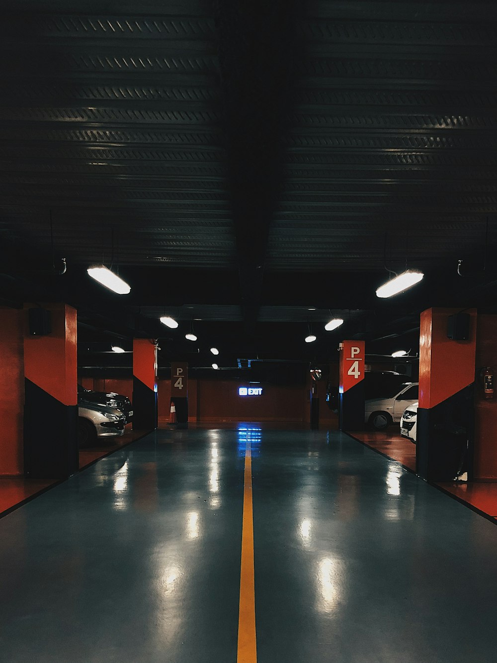 an empty parking garage with a yellow line painted on the floor