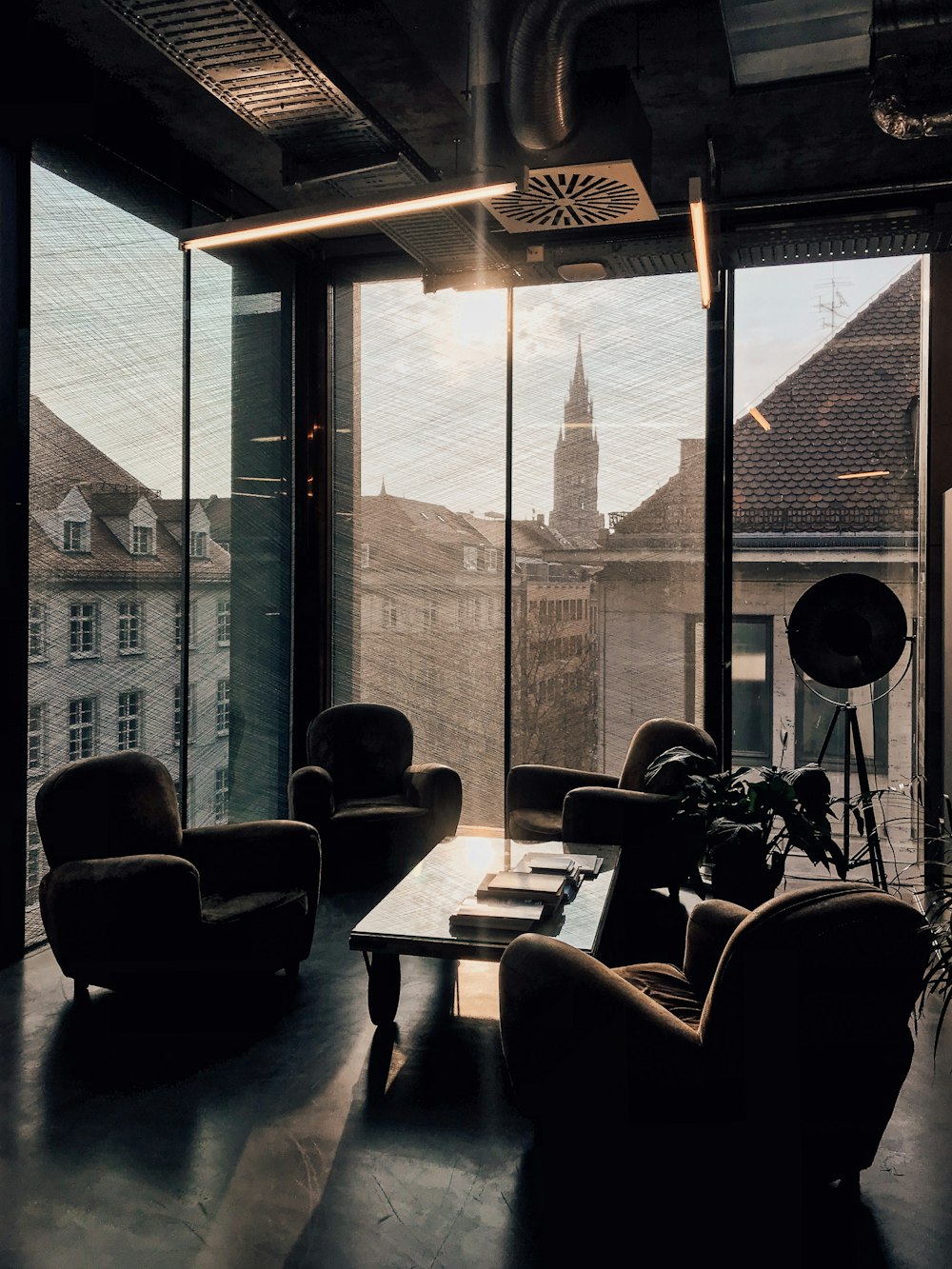 vacant sofa chairs beside glass window