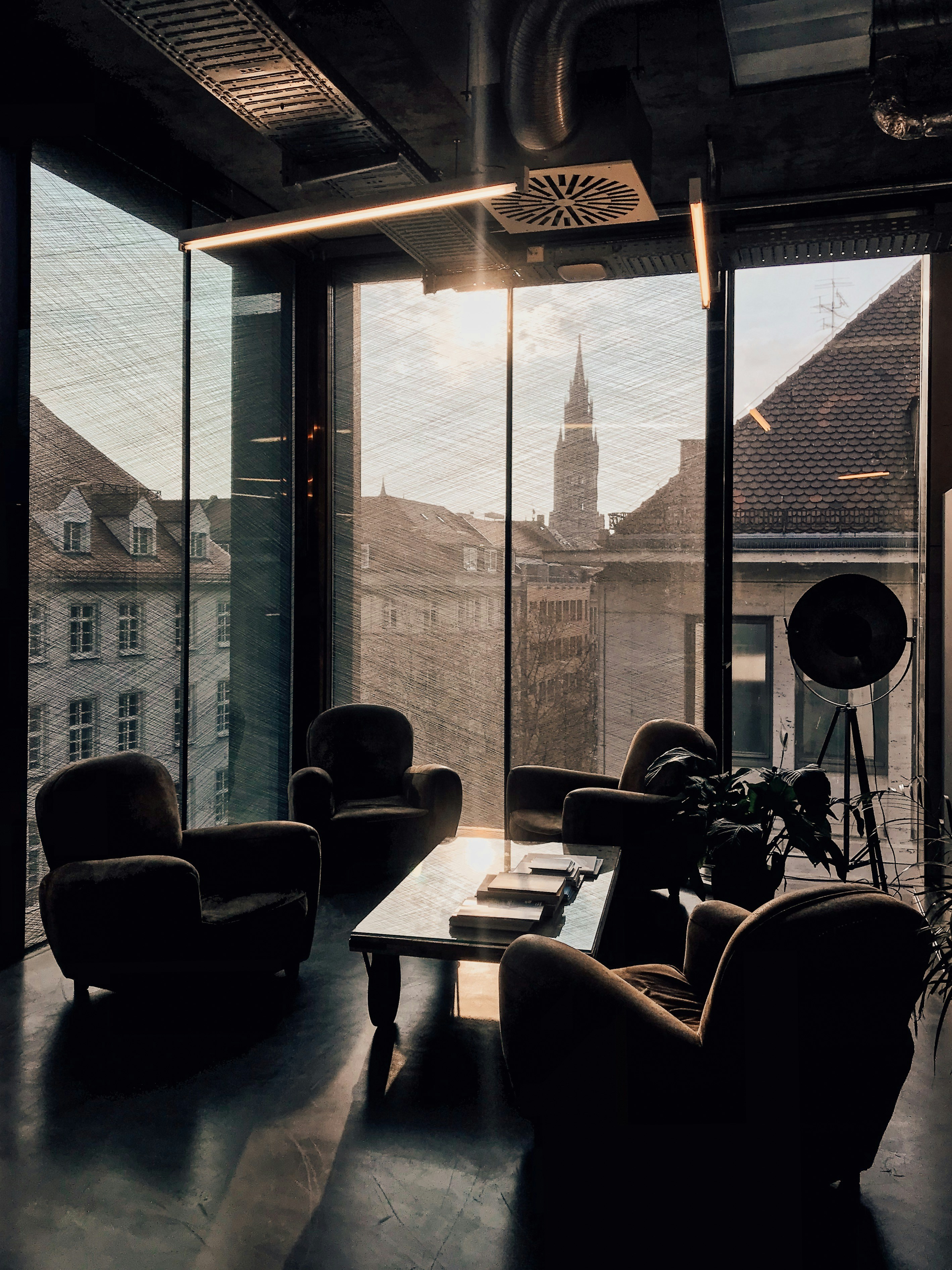 vacant sofa chairs beside glass window